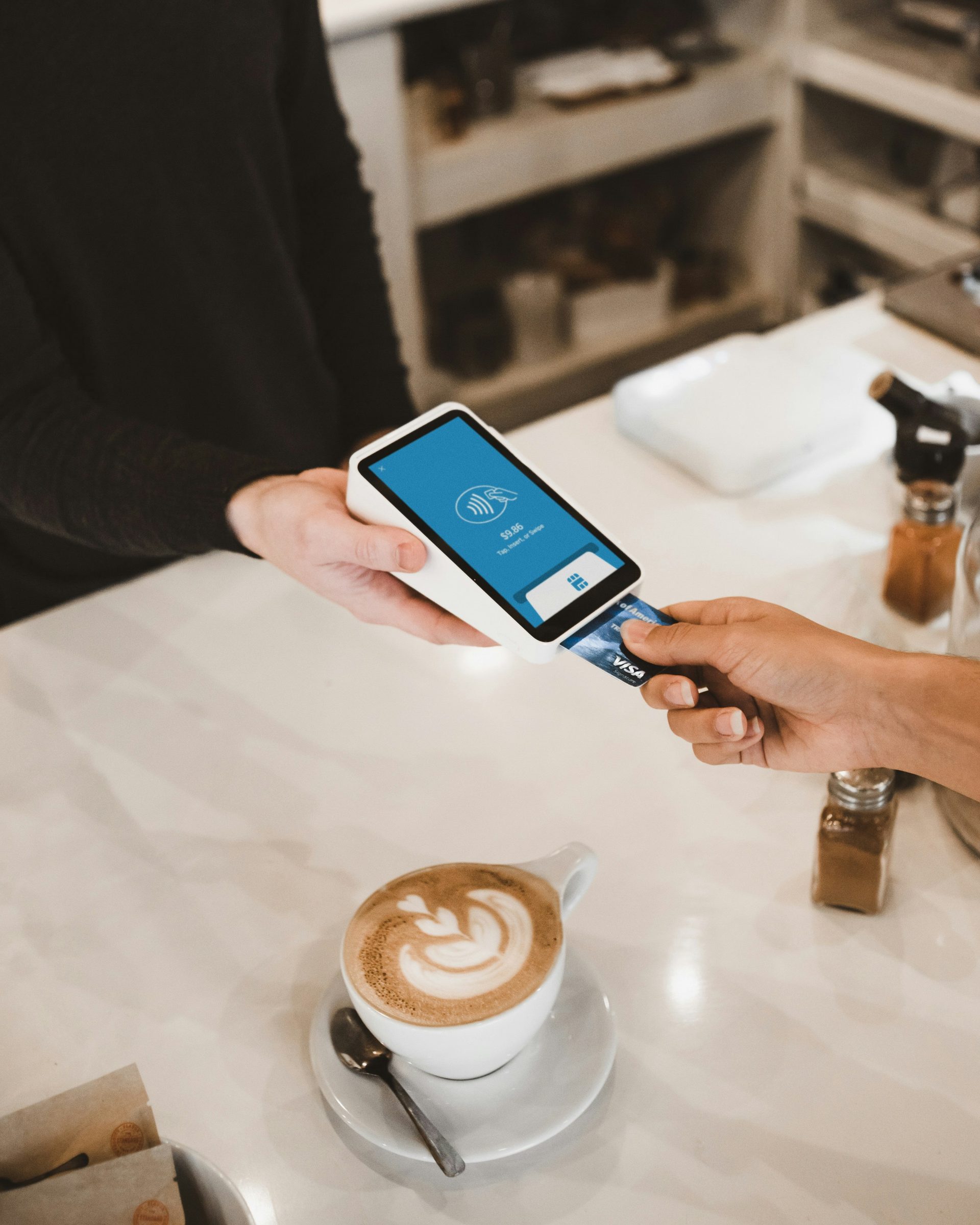 A San Diego business owner accepting a card payment on a modern POS terminal